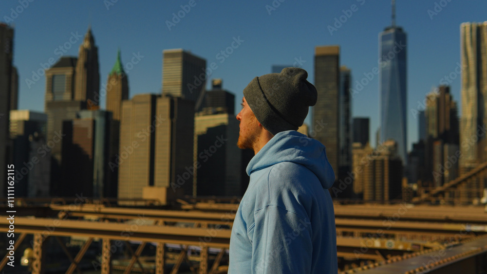A man standing with Manhattan skyline views in New York City, USA A man standing with Manhattan skyline views in New York City, USA