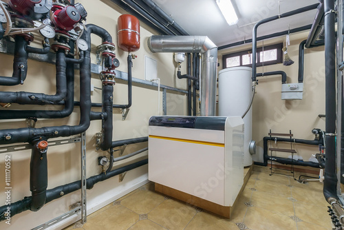 A modern boiler sits against a wall in a well-organized residential basement. Surrounding it is an intricate network of black pipes, indicating a sophisticated heating system.
