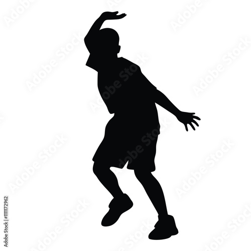 A boy is playing basketball. He is wearing a black shirt and shorts. He is jumping up in the air