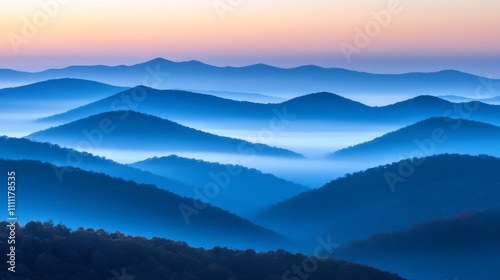 Silhouetted Mountain Ranges and Fog in a Blue Hue at Dusk