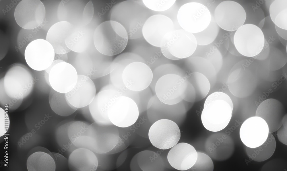 Soft silver and white bokeh lights creating a dreamy defocused background for artistic and design purposes. Soft silver and white bokeh lights creating a dreamy defocused background for artistic and design purposes.