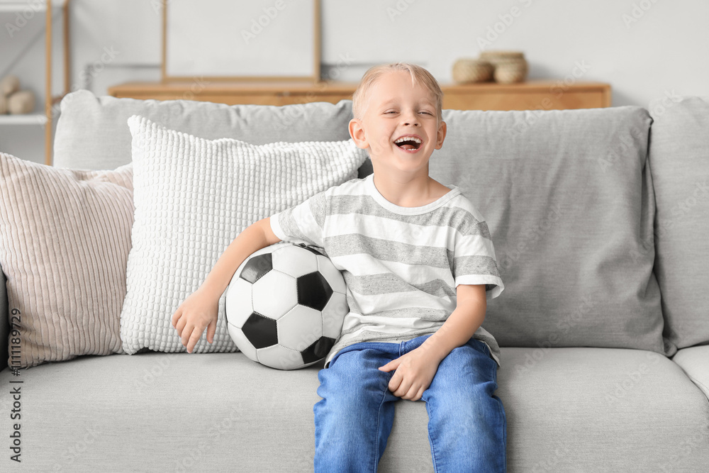 Cute little boy with soccer ball at home Cute little boy with soccer ball at home