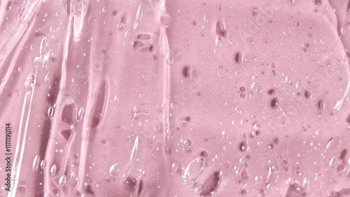 Liquid serum gel on pink background, cosmetic texture with bubble. Moisturizing beauty care products concept.