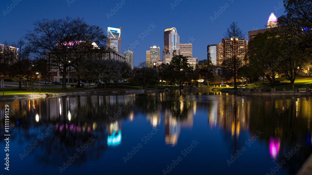 View of Charlotte, North Carolina at sunrise reflecting in pond at Marshall Park View of Charlotte, North Carolina at sunrise reflecting in pond at Marshall Park