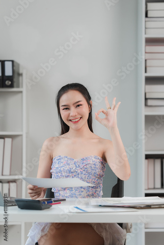 Confident Businesswoman Showing Ok Sign