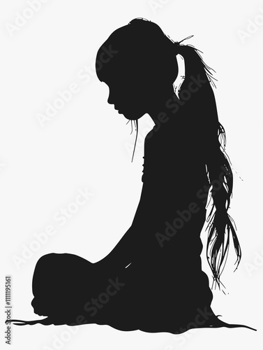 Girl is sitting on the ground with her hair in a ponytail. She is looking down and she is sad