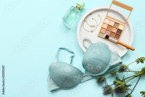 Composition with stylish female bra, cosmetics and plant branch on color background photo