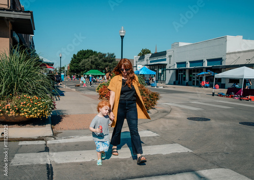 Mother and Son Crossing a Street in a Downtown Area