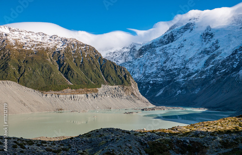 Stunning mountain landscape with clouds covering peaks mt cook new zealand national park winter snow peaks photo