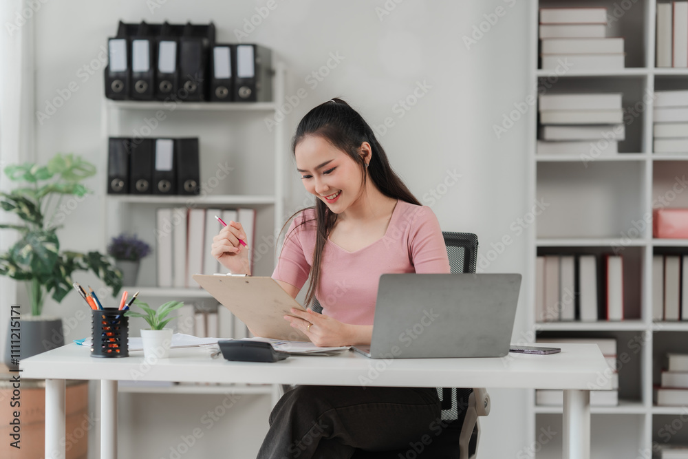 Focused and Confident: A young professional woman in a modern office, immersed in her work with a focused expression. She exudes confidence and determination as she navigates her tasks. Focused and Confident: A young professional woman in a modern office, immersed in her work with a focused expression. She exudes confidence and determination as she navigates her tasks.
