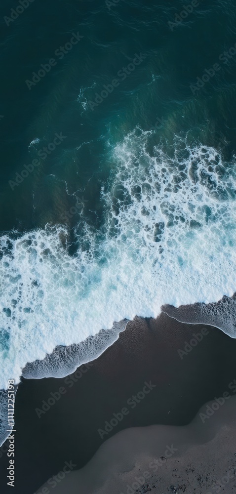 Dark blue sea waves crashing on dark beach. Powerful ocean waves meet black sand shore. Water foams and sprays. Nature background wallpaper for phone or stories. Dark blue sea waves crashing on dark beach. Powerful ocean waves meet black sand shore. Water foams and sprays. Nature background wallpaper for phone or stories.