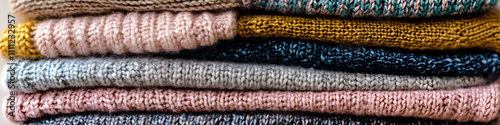 Cozy knitted sweaters stacked in a warm and inviting arrangement for winter fashion