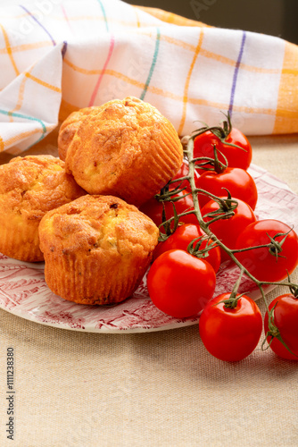 savory snack cakes muffins with corn and tomatoes - selective focus