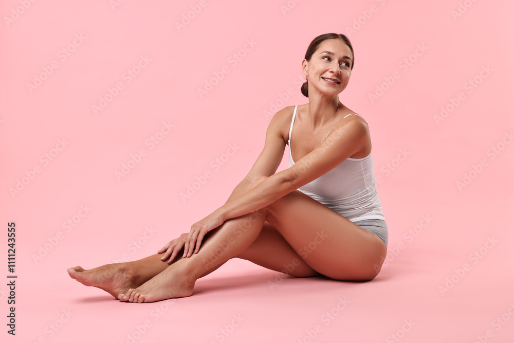 Smiling woman with perfect skin posing on pink background. Body care Smiling woman with perfect skin posing on pink background. Body care