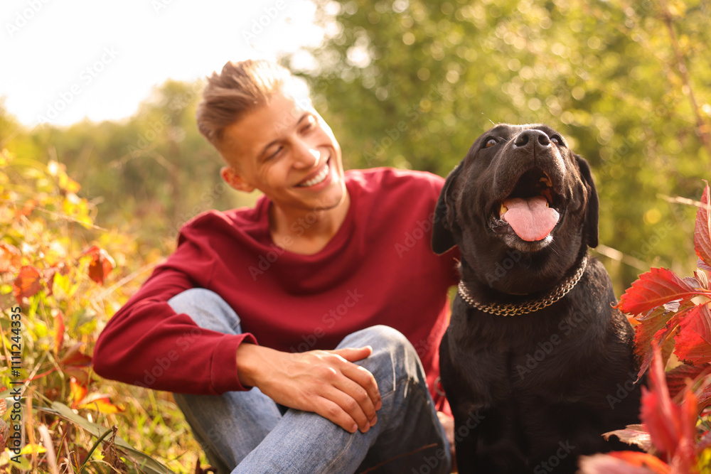 Smiling man with cute dog outdoors on autumn day, selective focus Smiling man with cute dog outdoors on autumn day, selective focus