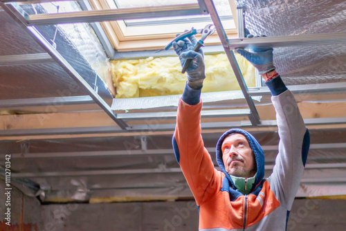 Installing skylight windows in mansard garret, or attic. Installation of suspended ceilings, thermal insulation,  vapor-permeable foil.  Roofer and window master work.