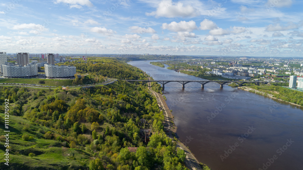 Fototapeta premium City with a river running through it and a bridge over it