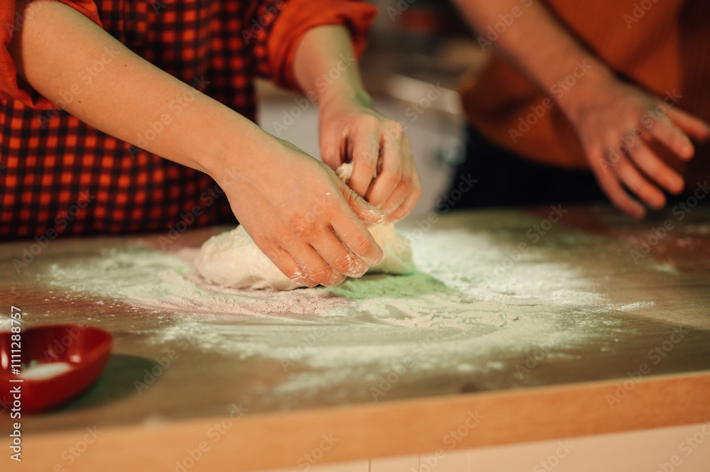 Chef kneading dough on floured wooden table in kitchen Chef kneading dough on floured wooden table in kitchen