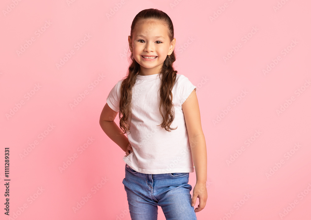 Child Portrait. Adorable casual asian baby posing at camera isolated on pink background Child Portrait. Adorable casual asian baby posing at camera isolated on pink background