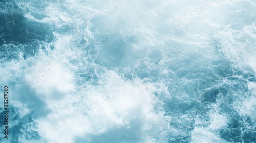 Aerial view of turbulent ocean waves and foam.