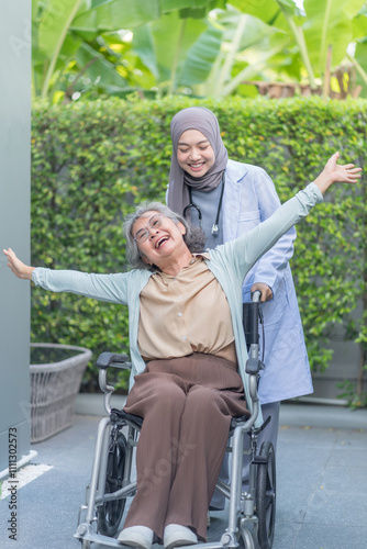 a doctor giving good news to a senior cancer patient on wheelchair,elderly woman happy,doing hands up and laughing and fool around