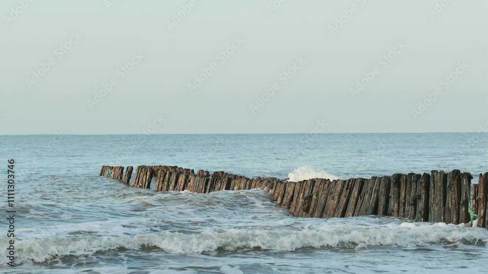Breakwater Structure Withstands Ocean Waves at Coastal Shoreline During Sunrise Breakwater Structure Withstands Ocean Waves at Coastal Shoreline During Sunrise
