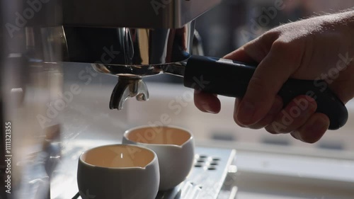 Perfectly brewing espresso cups with a hand portafilter on a coffee machine