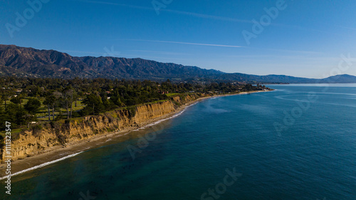 DECEMBER 2022, SANTA BARBARA, CA - USA - aerial view of famous Santa Barbara beach bluffs and with mountains and palm trees in background - near Montecito photo