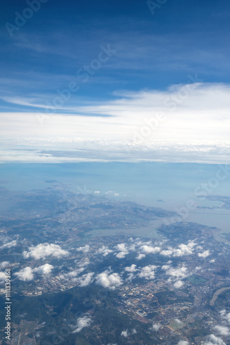 Serene Aerial View of Coastal Landscape with Clouds and Blue Skies