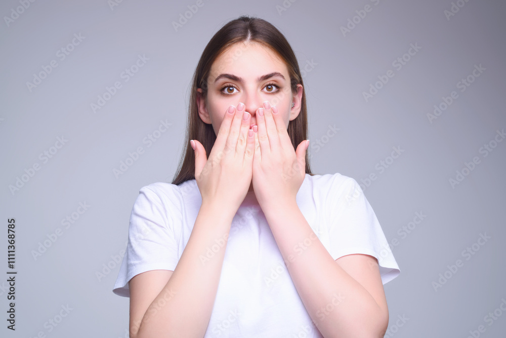 Girl raising eyebrows being surprised and shocked. Astonished reaction on unexpected news. Girl in t-shirt on isolated studio background with shocked, surprise and amazed expression on face. Girl raising eyebrows being surprised and shocked. Astonished reaction on unexpected news. Girl in t-shirt on isolated studio background with shocked, surprise and amazed expression on face.