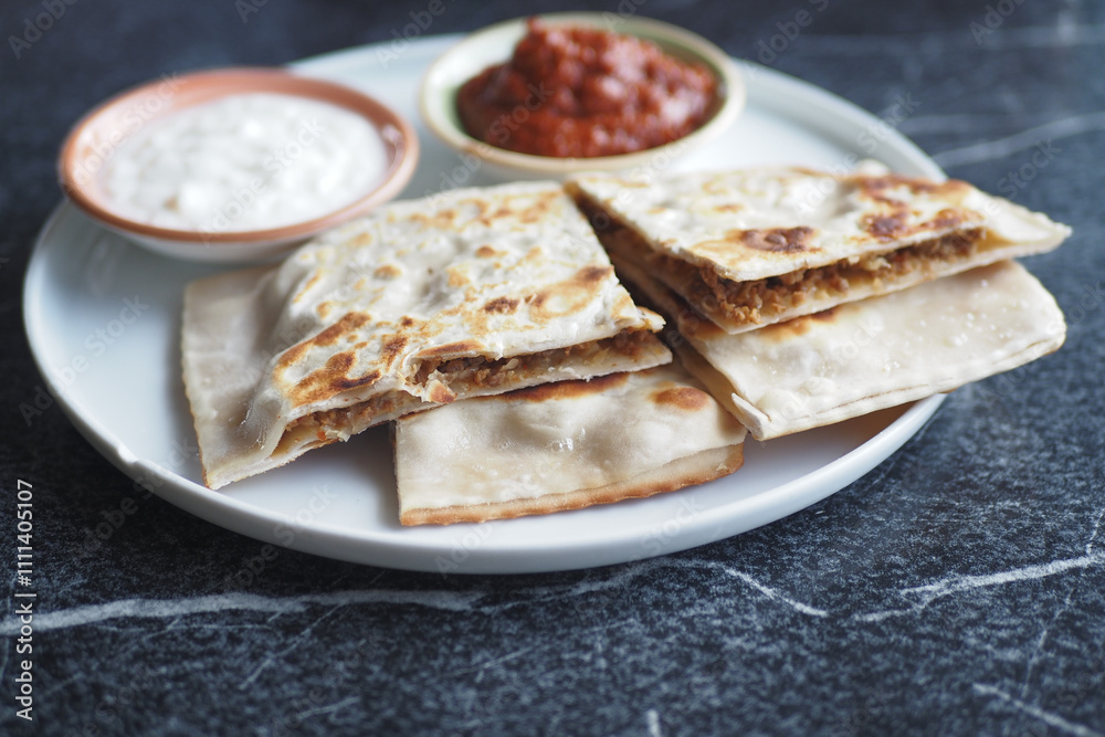 A Delicious Indian Flatbread Served with Various Dips and Sauces A Delicious Indian Flatbread Served with Various Dips and Sauces