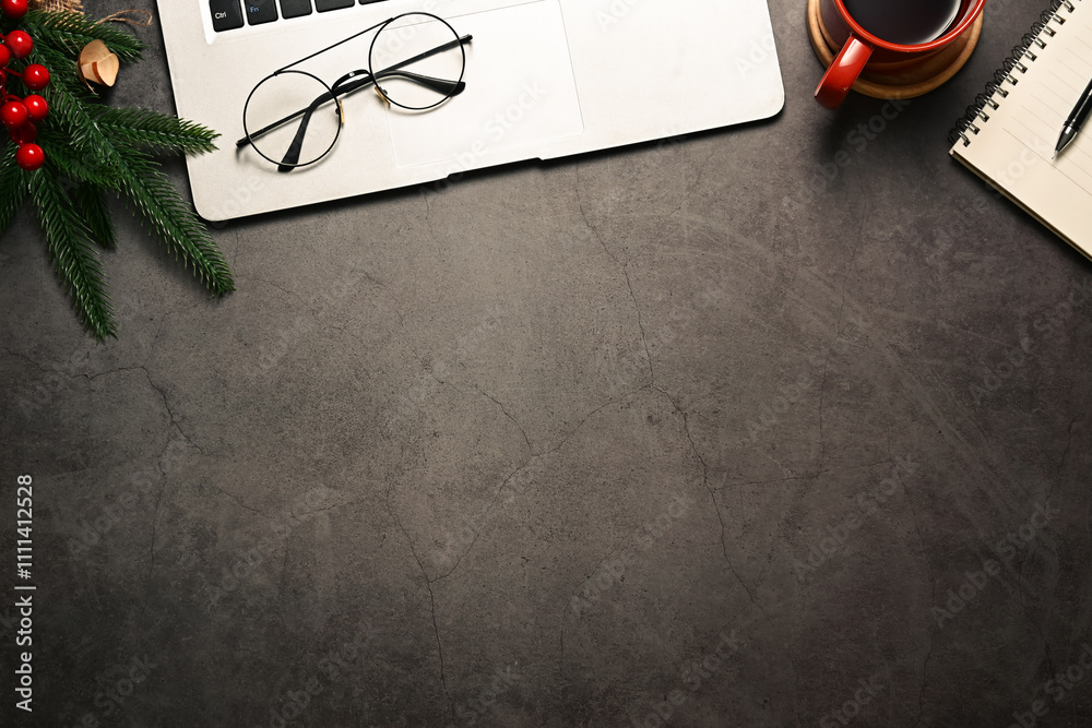 Fototapeta premium Beautifully arranged desk with gift wrapped in festive paper, laptop, coffee cup and pine branches