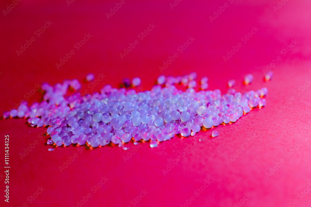 a bunch of scattered silica gel isolated on red background a bunch of scattered silica gel isolated on red background