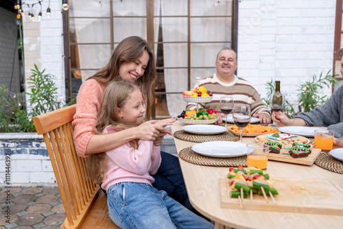 Caucasian family having fun and enjoying party outdoors in the garden. photo