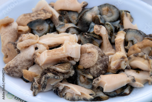 sashimi of conch and sea cucumber on the dish photo