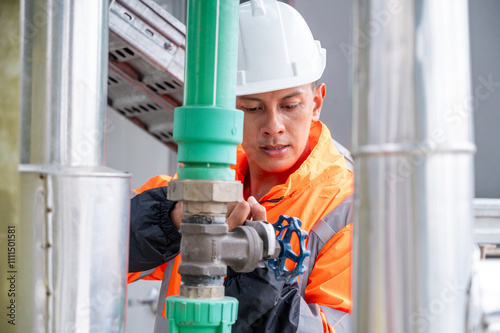 The image captures a skilled engineer inspecting a network of pipelines in a petrochemical facility. the concept of projects related to petrochemicals, engineering, and industrial inspection.