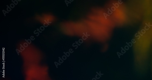 Abstract blur. Flare light. Sparkling blinking yellow orange blue multicolor gleaming bright flickers moving on dark art background.