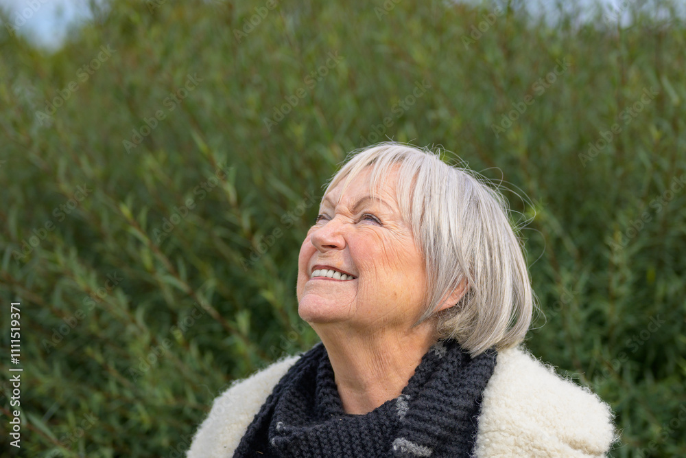 Elderly Woman Smiling Upwards in a Natural Setting Elderly Woman Smiling Upwards in a Natural Setting