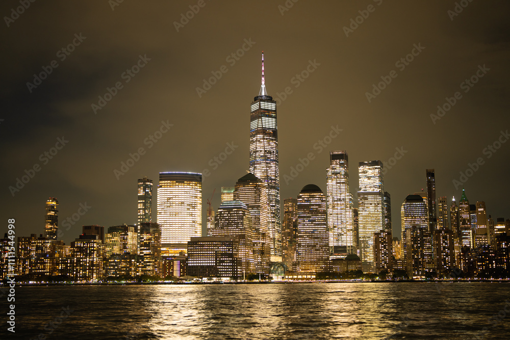Obraz premium Night in The NYC city, USA, United States. Night day with iconic buildings. New York City NYC Manhattan Downtown Skyline, viewed from Jersey City, USA.