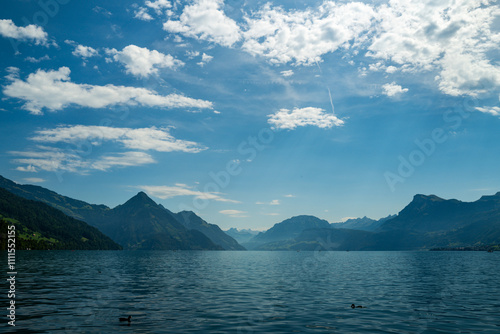 Blue nature background. Blue lake with blue sky near blue mountain.