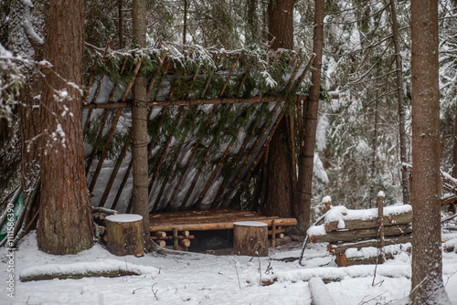 Outdoor bushcraft camp in the forest
Primitive Bushcraft survival debris hut with campfire ring outside