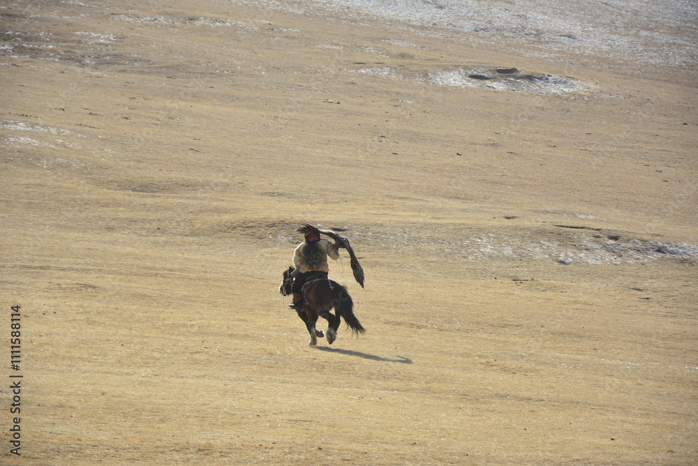 The Eagle Hunter taking his golden eagle to the mountain for hunting The Eagle Hunter taking his golden eagle to the mountain for hunting