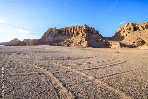 Desert sand road and Yardang landform mountain natural landscape in Xinjiang. Road trip in no man's land. Famous Dahaidao desert gobi scenery in China. photo