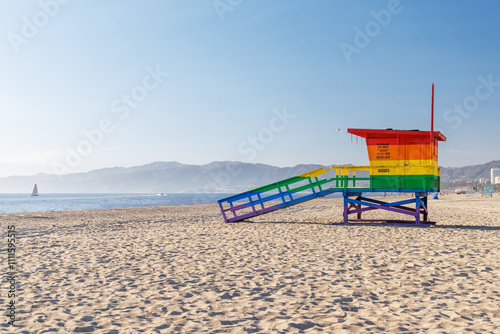 Vibrant lifeguard tower painted in LGBTQ rainbow colors photo