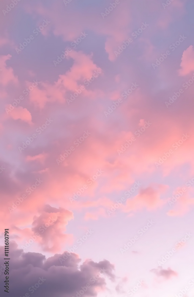 Obraz premium Soft pastel pink and lavender clouds at dawn with a hint of sunlight phone background wallpaper
