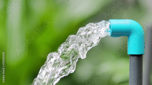 Refreshing Flow: Pure water gushes from a blue PVC pipe, symbolizing purity, freshness, and the life-giving essence of hydration.  