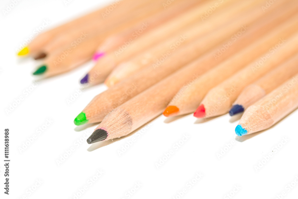 A row of pencils with different colors and one with a green tip A row of pencils with different colors and one with a green tip