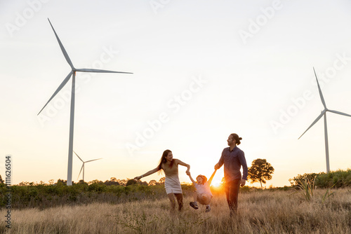 Wallpaper Mural Family with son walking on field on wind farm. Happy Family and son playing at the Wind turbines generating electricity. Family time together. Torontodigital.ca