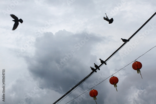 Red paper lanterns series as decoration for Chinese New Year celebration with cloudy sky in the background.