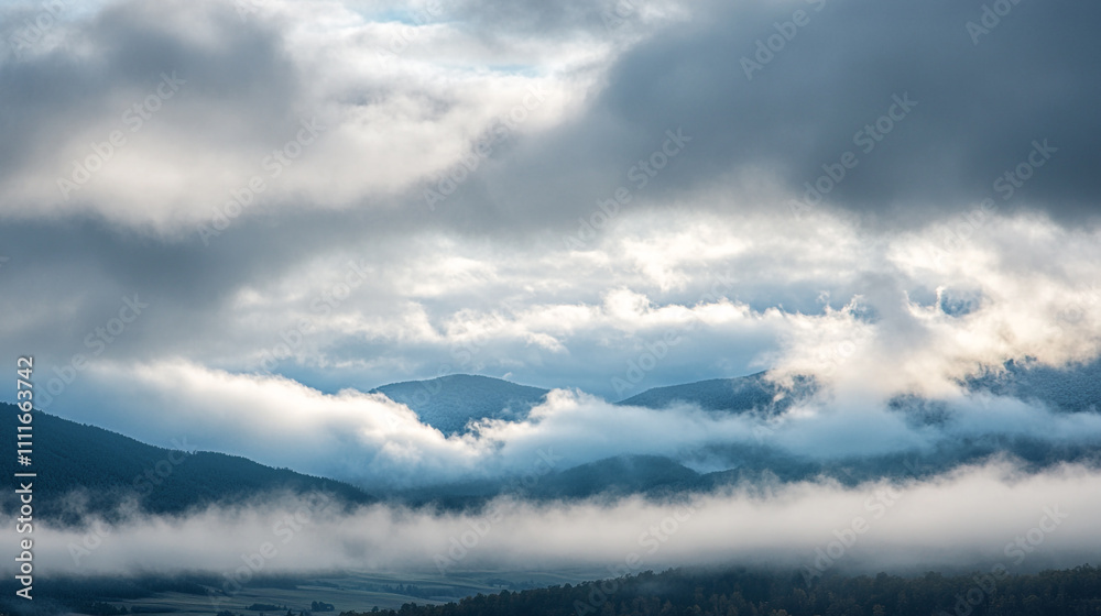 Obraz premium Majestic mountain landscape shrouded in mist during early morning light